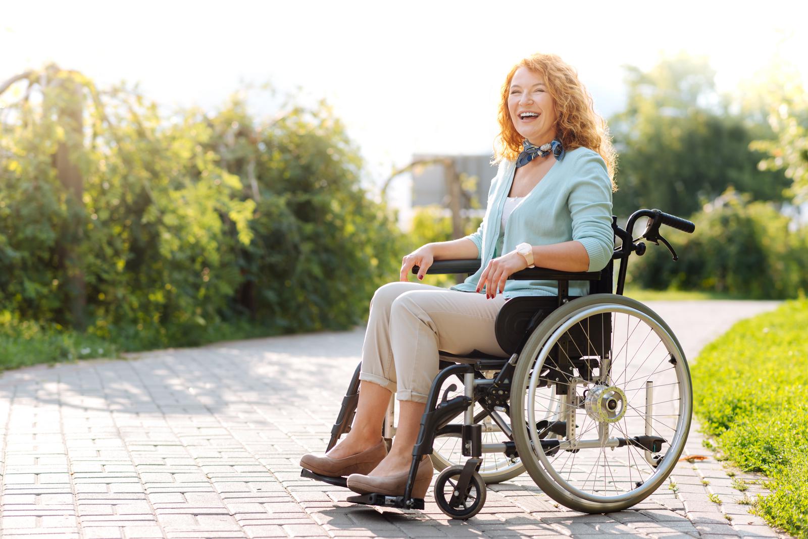 Woman using her manual wheelchair outside